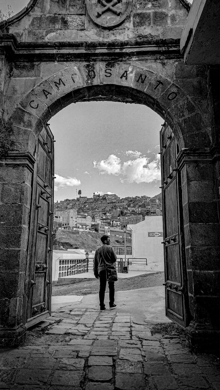 historic cemetery archway in black and white