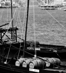 vintage boats and wine barrels on douro river