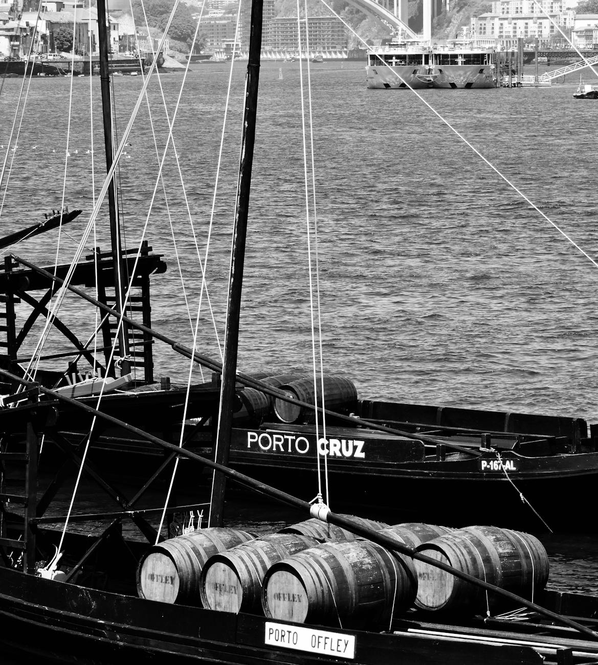 vintage boats and wine barrels on douro river