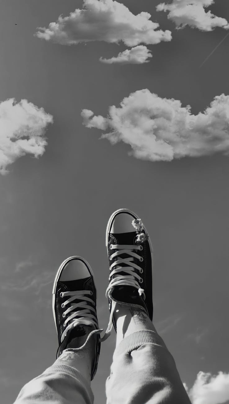 person lying with legs up on the background of the sky