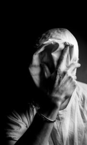 a person covering their face