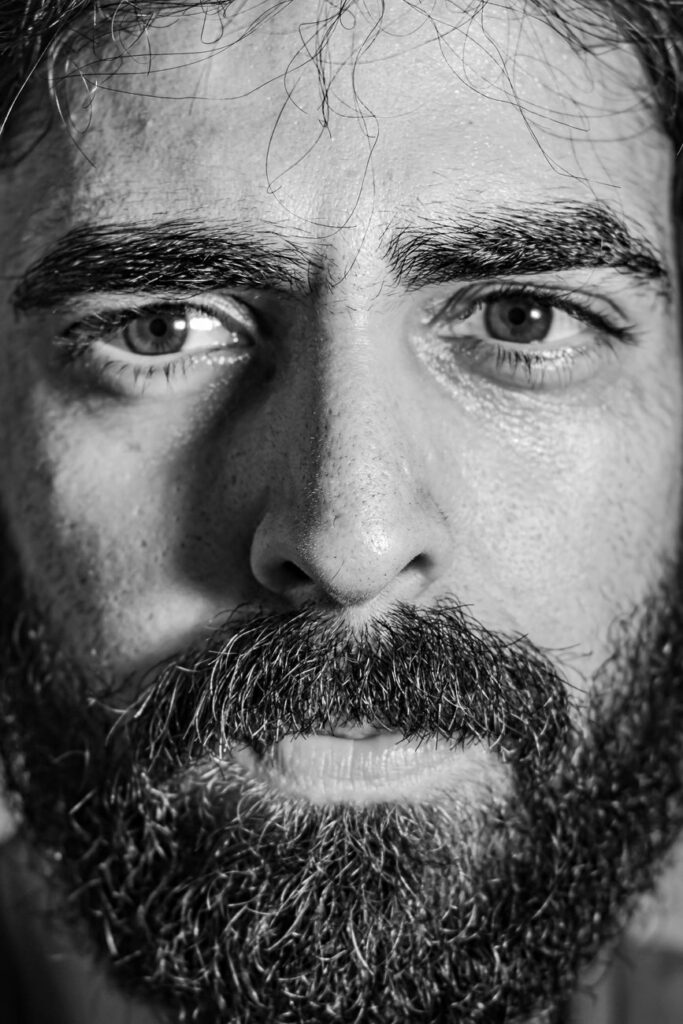 black and white close up of a bearded man